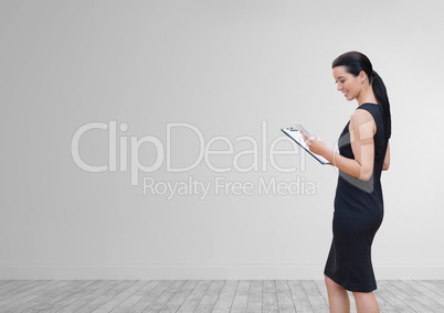 Happy business woman using a phone against white wall background