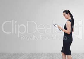 Happy business woman using a phone against white wall background