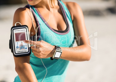 Woman exercising using a phone with E-Learning information in the screen
