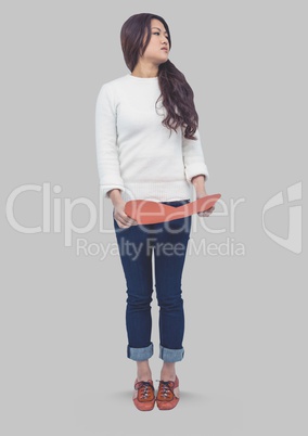 Full body portrait of woman holding heart and standing with grey background