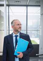 Confused business man standing against building background