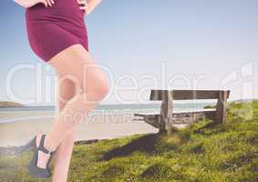 Sexy woman's legs by a bench at the sea