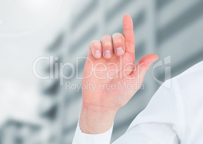 Hand pointing up in front of buildings