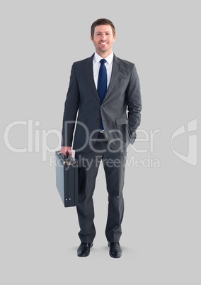 Full body portrait of man standing with grey background