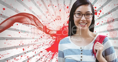 Happy young student woman standing against white and red splattered background