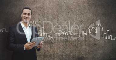 Happy business man holding a tablet against grey wall background with city icons