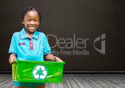 Boy holding recycling box in front of blackboard