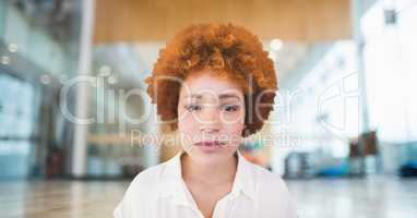 Business woman standing against office background