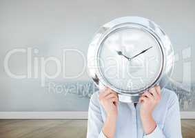 Woman holding clock in front of city in room