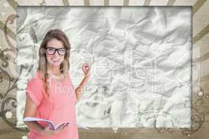 Happy young student woman holding a notebook against brown and white splattered background