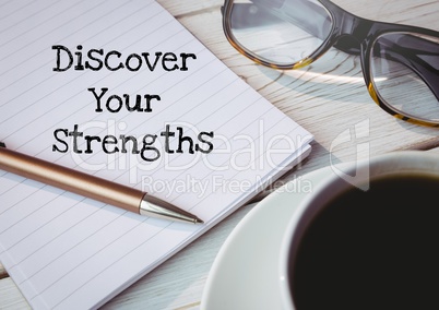 Discover your strengths  text written on page with glasses and coffee