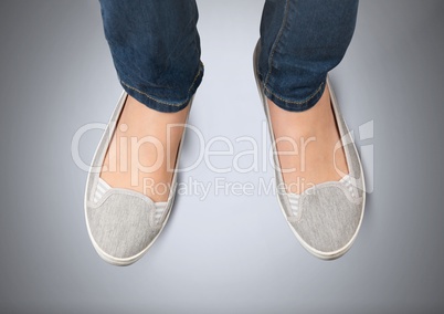 Woman's feet on grey background