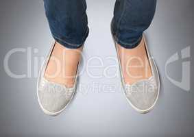 Woman's feet on grey background