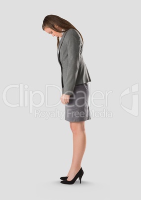 Full body portrait of woman standing with grey background