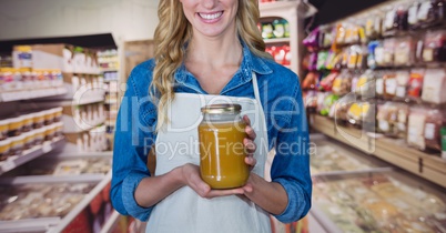 Happy small business owner woman holding a jar