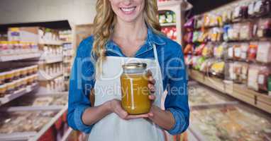 Happy small business owner woman holding a jar