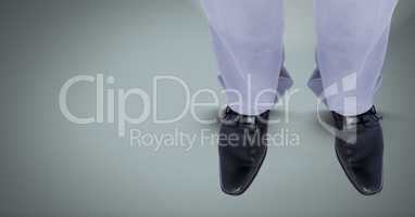 Businessman's feet and shoes on blue background