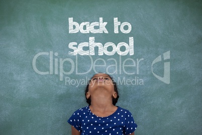 Office kid girl looking up against green background with back to school text