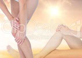 Slim woman fading into position holding leg in front of gentle sky