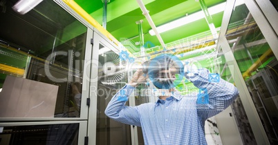 Digitally generated image of various icons with businessman using binoculars in office