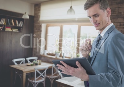 Businessman holding tablet in cafe restaurant