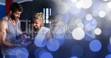 People in gym with clipboard and blue bokeh transition