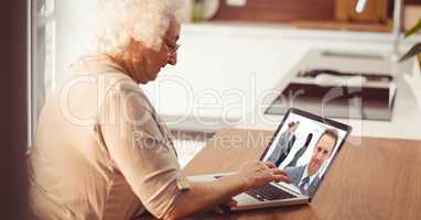 Senior woman video conferencing on laptop
