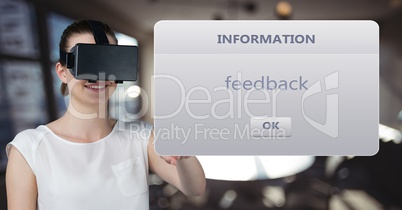 Businesswoman wearing VR glasses reading text while standing against defocused background