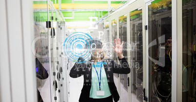 Businesswoman wearing VR glasses with virtual screen in foreground