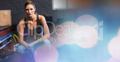Woman crouching in gym and blue pink bokeh transition