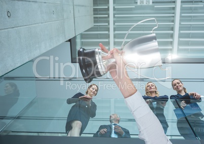 business hand with trophy in over the balcony with more business men and women