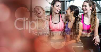 Fit young women smiling in gym