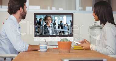Business people video conferencing with colleague on computer