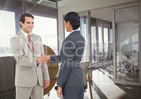 business man and woman hand shake in the office, in front of the meeting room