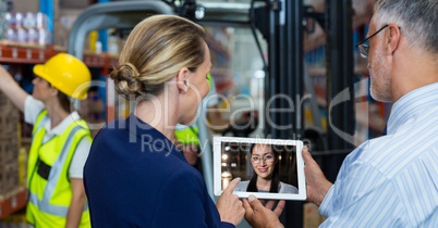 Man and woman video conferencing with colleague