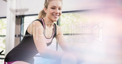 Smiling fit woman exercising in gym