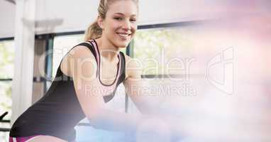 Smiling fit woman exercising in gym