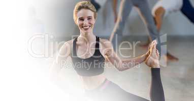 Smiling woman performing yoga in gym