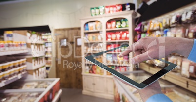 Hand taking picture with tablet PC at grocery store