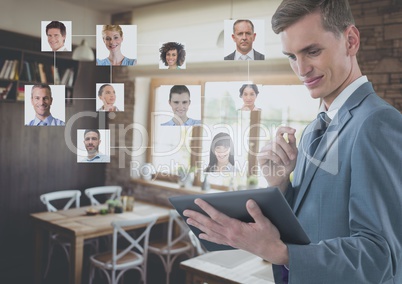 Businessman holding tablet with people's profile pictures in cafe restaurant