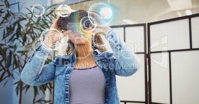 Digital composite image of woman wearing VR glasses