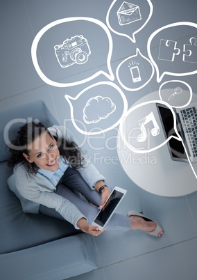 Overhead of business woman sitting with white speech bubbles