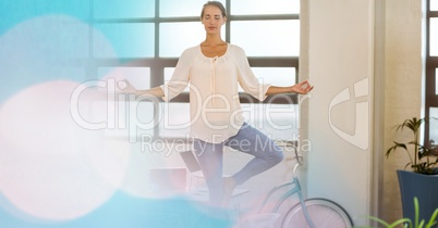Fit woman meditating in gym