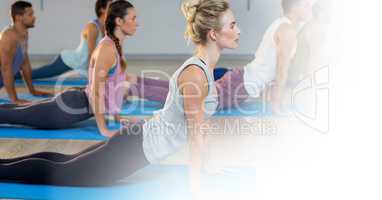 People doing yoga on floor in gym