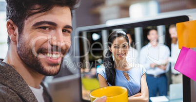 Businessman video conferencing with colleagues in office