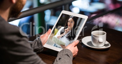 Businessman having video conference with woman on tablet PC