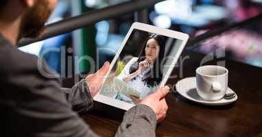 Businessman having video conference with woman on tablet PC