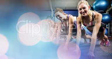 Smiling females exercising in gym