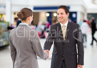 business woman and man handshake. shopping centre