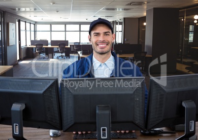 security guard behind the screens, smiling. In the office